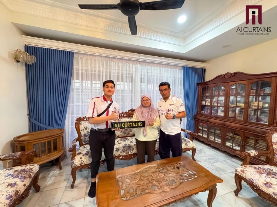 Two Ai Curtains staff standing with a customer in a finished living room, holding the company's plaque, with blue drapes and sheers at the window behind them.