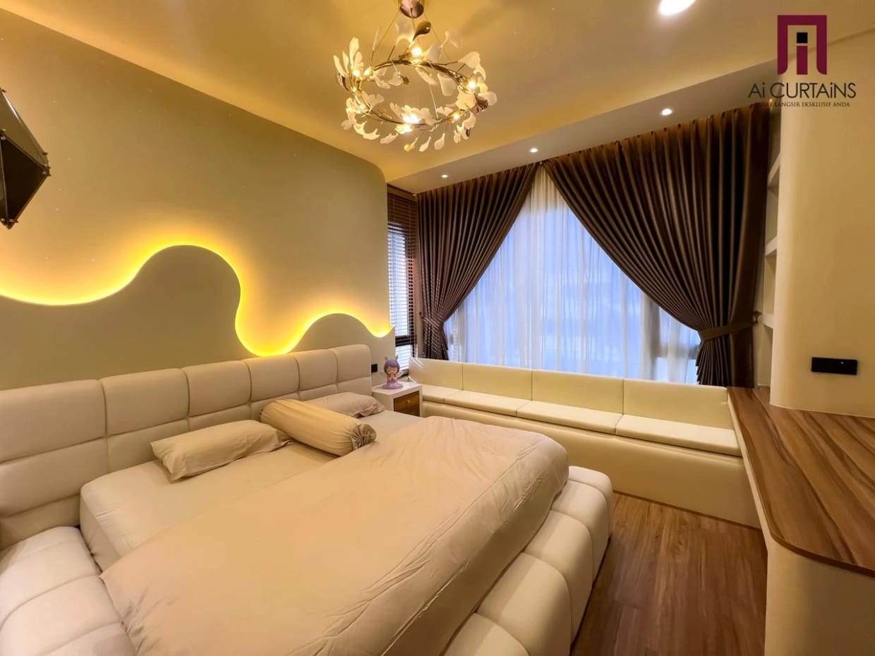A bedroom with a curved cove-lit ceiling, brown floor-length drapes at the window and a sheer panel drawn across it.