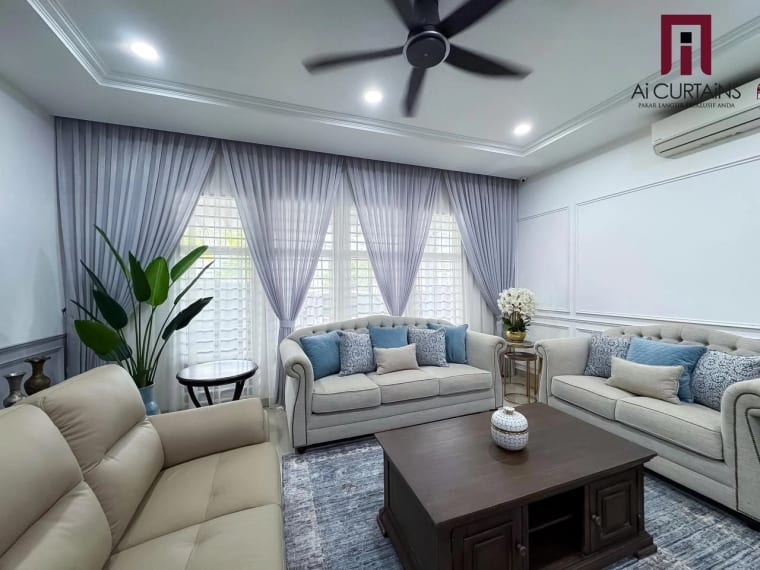 The same living room from the front, both windows dressed the same way, with the drapes held back and the sheers left closed.